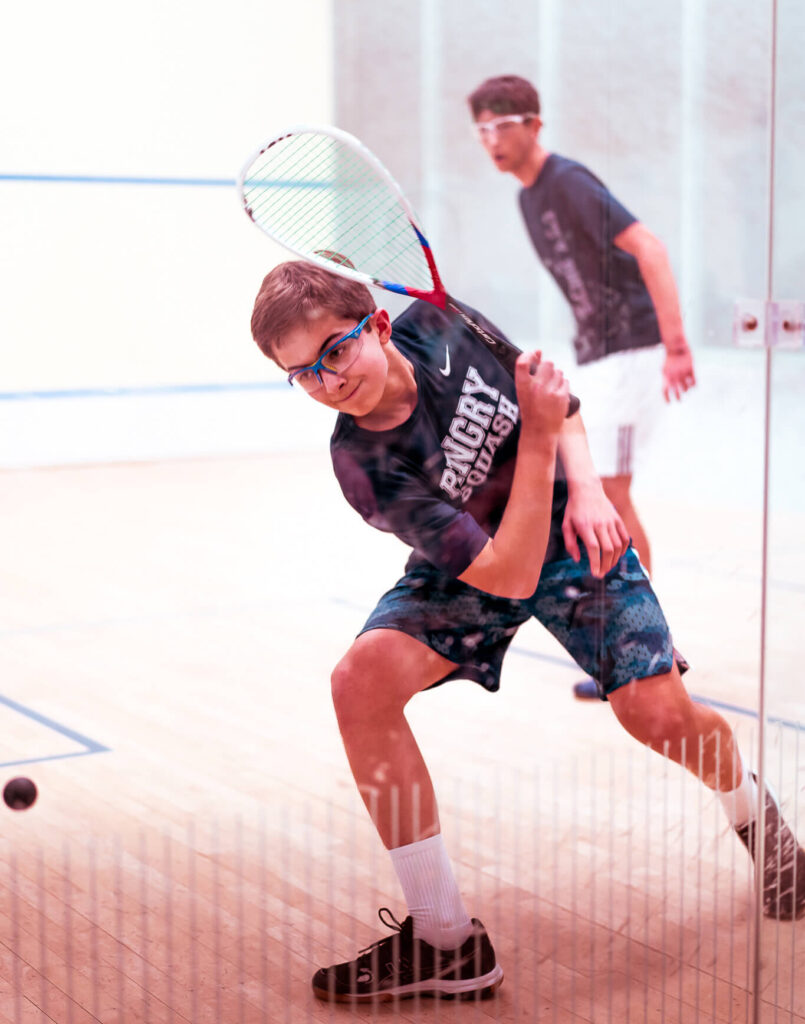 teen boys playing squash