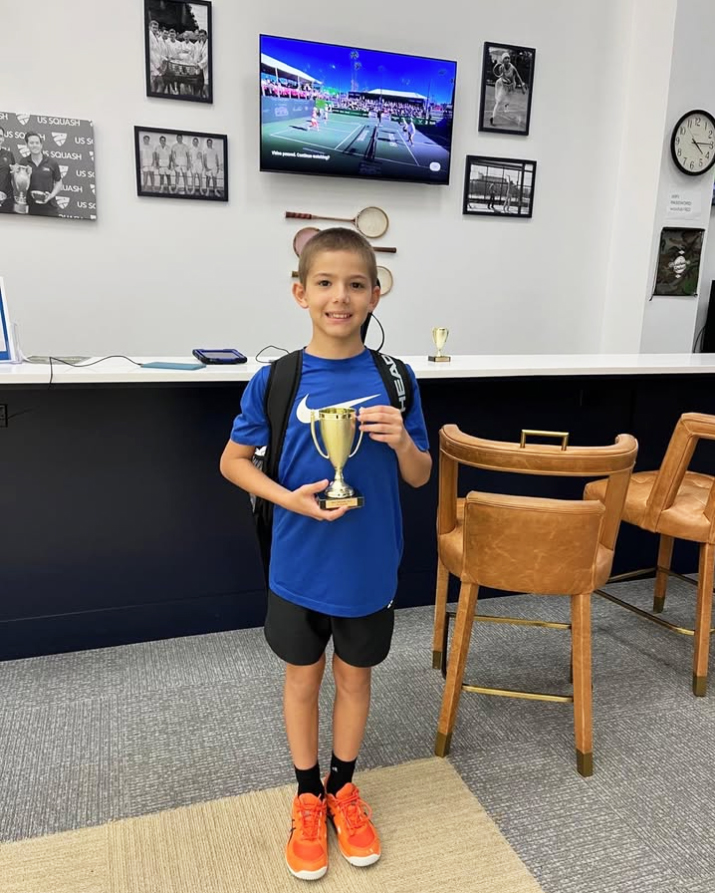 young boy squash winner